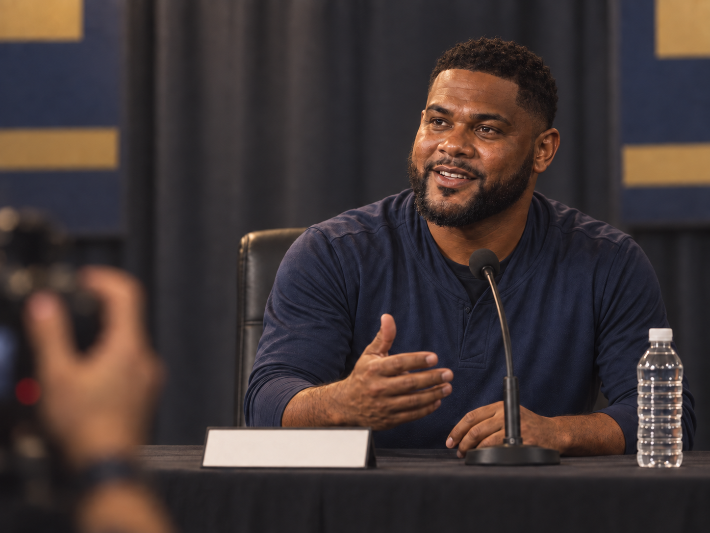 A fictional Latino baseball player speaking confidently at a press conference.